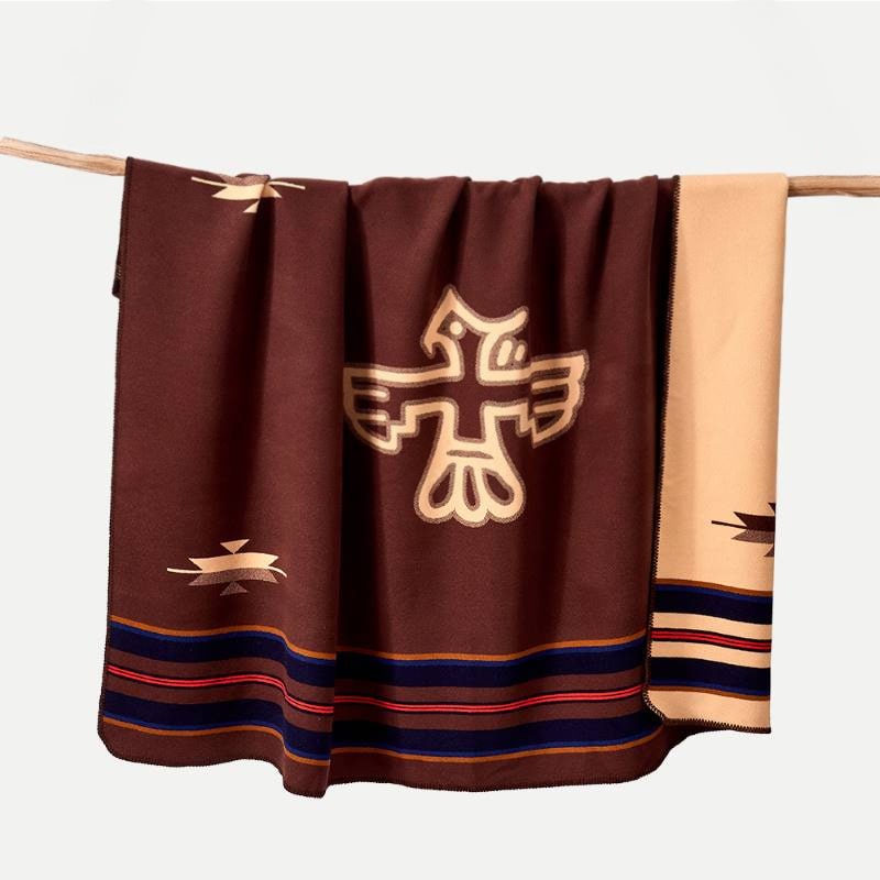 Anifurry Thunderbird Merino Wool Blanket hangs on the wood.